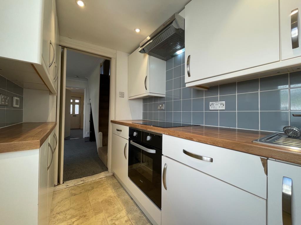 Lot: 107 - TWO-BEDROOM TERRACE HOUSE - Fitted kitchen at the rear of the house